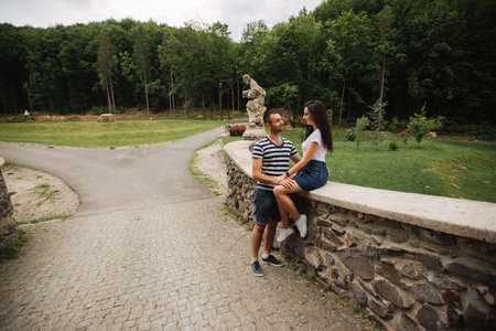 Young couple in love spending time together near the big old bridgeの写真素材