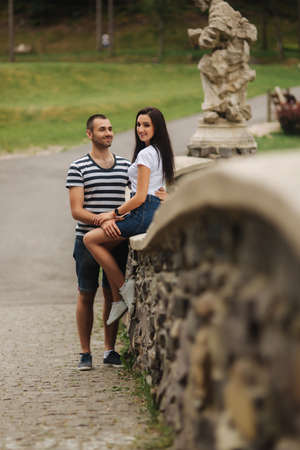 Young couple in love spending time together near the big old bridgeの写真素材