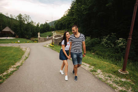 Young couple in love spending time together near the big old bridgeの写真素材