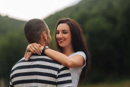 Beautiful couple walking in the park near the lakeの写真素材