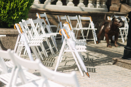 White chair with white umbrella. Wedding ceremony