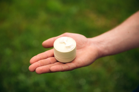 Man makes a marrige proposal to a girl. Gives her a ring for the engagement. Close-up handsの写真素材