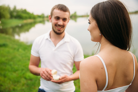 Man makes a marrige proposal to a girl. Gives her a ring for the engagement.の写真素材