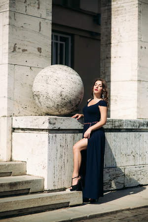 A beautiful girl in a dress is walking around the cityの写真素材