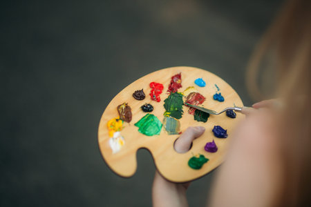 Palette with paints and spatula. Drawing a picture.