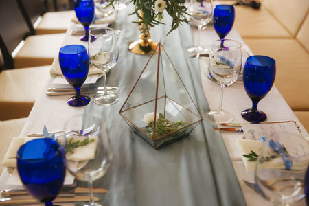 Table appointsment in restaurant. Wedding decoration in blue style
