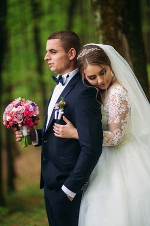 Romantic couple of newlyweds in the middle of forestの写真素材