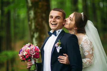 Romantic couple of newlyweds in the middle of forestの写真素材