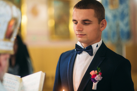 groom give a vow of love in the churchの写真素材