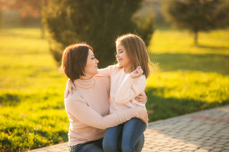 Mom and daughter spend time together. Autumn weatherの写真素材