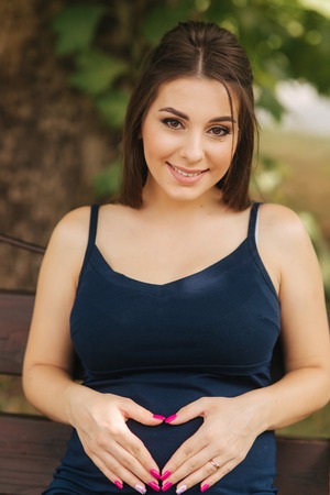 Close up of beautiful pregnant woman. Happy lady smile and rejoicedの写真素材