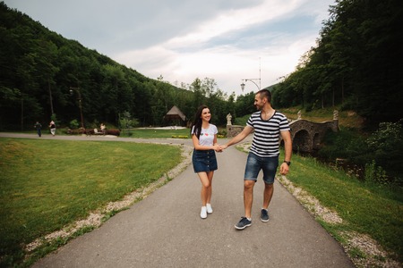 Beautiful couple walking in the park near the lake.の写真素材