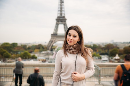 Attractive young lady stand in centre of paris. Background of eiffel tower. Travelの写真素材