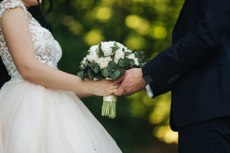 Lovely couple walkink in the park on their wedding dayの写真素材
