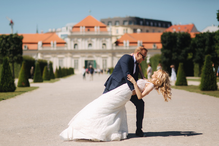 Groom dance with bride in the pakr near the palace in Wiena, Austriaの写真素材
