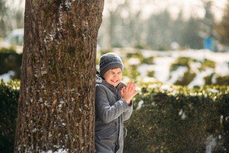 In perfect winter weather the boy poses to the photographerの写真素材