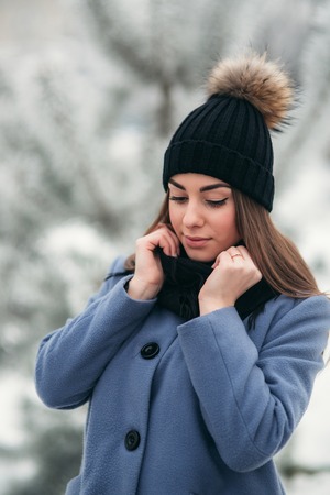 Beautiful winter portrait of young woman in the winter snowy sceneryの写真素材