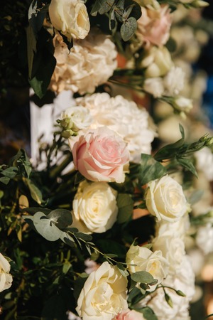 Floral decoration on the wedding ceremony by the restaurant. Pink and white color of rose. Elegant decor on charming weddingの写真素材