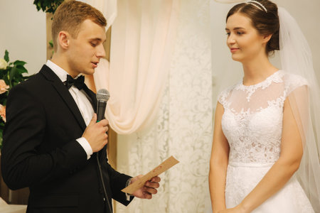 Groom and bride at the wedding ceremony in the churchの写真素材