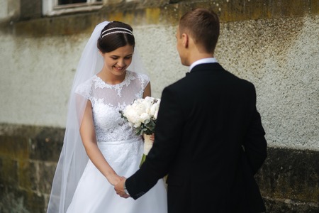 Happy newlyweds spend time together in their wedding day. Groom and brideの写真素材