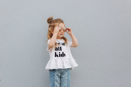 little girl in sunglasses posing to photographer
