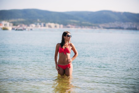 Beautiful girl in a pink bathing suit, in the sea. Sexy ladyの写真素材