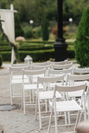 White chair on wedding ceremony. summer wedding decoration outsideの写真素材