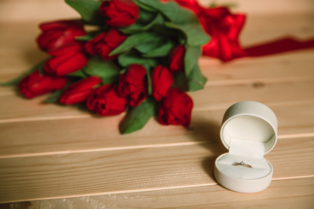 Bouquet of red tulips and diamond ring for marriageの写真素材