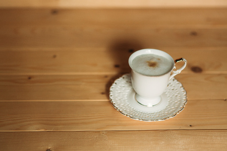 Beautiful cappuccino on a wooden background. White cupの写真素材