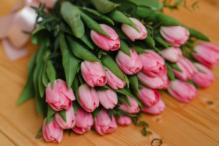 Bright pink flowers on wooden background. Colorful bouquet for Mothers Day, Birthday, International Womens Day March 8の写真素材