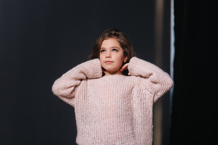 Beautiful young model in a peach color knitted sweater. Fashion makeup and hairstyleの写真素材