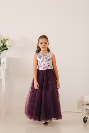 Happy child female in purple dress. Beautiful makeup and hairstyleの写真素材