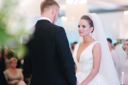 Happy newlyweds in restaurant. Groom and bride in their wedding dayの写真素材
