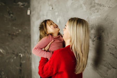 Happy family on the photosession in studio. Mother and daughterの写真素材
