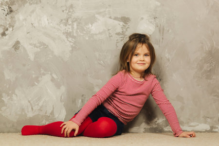 Beautiful little girl having fun at home. Five year old girl play at home