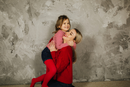 Happy family on the photosession in studio. Mother and daughterの写真素材
