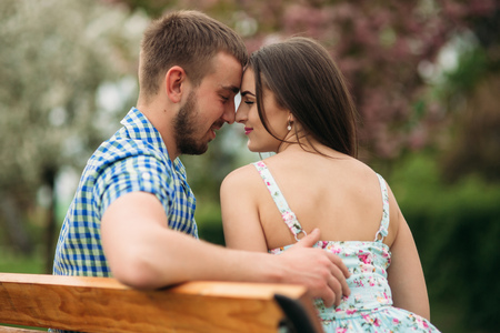 Happy couple kissing outside. Man and woman in the parkの写真素材