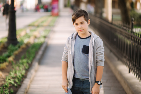 Cute boy walking in the city. Stylish teenage boy outsideの写真素材