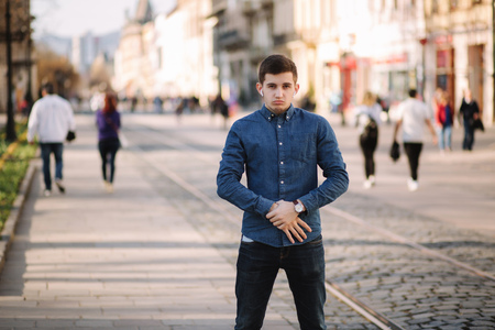 Photo of man standing in centre of the city. Stulish man walking outsideの写真素材