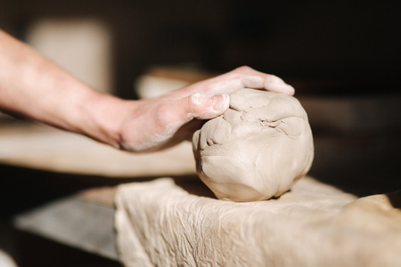 The clay lump on a potters wheel waits for the potter to turn into wareの写真素材