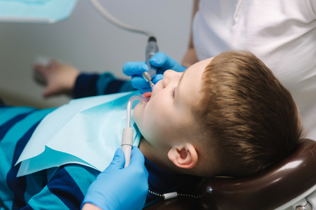 Young boy sitting on the dental chair at the office. Childrens dentist examination baby teethの写真素材