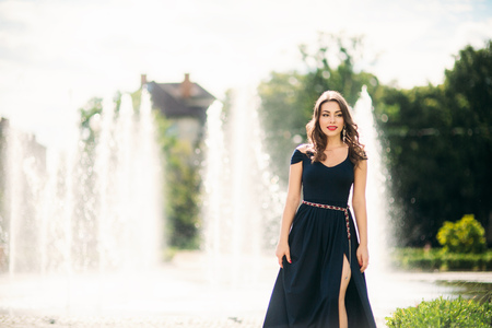 Attractive young model walk in the city. Background of fountainの写真素材