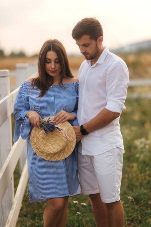 Pregnant woman and man hug each other and show their love. Couple waiting for baby girlの写真素材