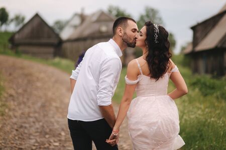 Groom kiss his beautiful bride. Couple walking in mountainsの写真素材