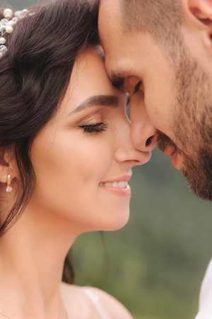 Close up portrait of beautiful couple in mountains. Happy woman with man. Elegant female with her...