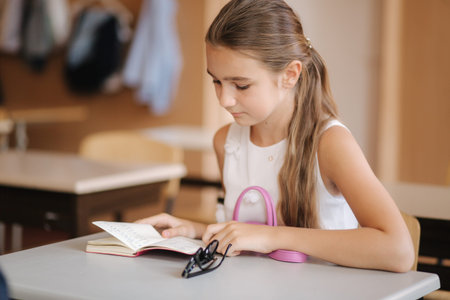 Schoolgirl take a notebook and write down homework