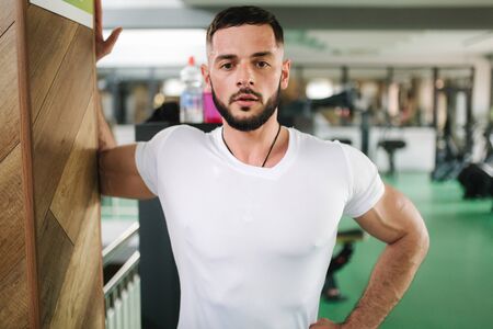 Man warm up in the gym. Handsome bearded man trainsの写真素材