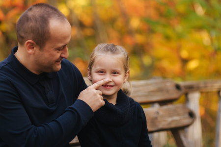 Father with little daughter walking in th forest