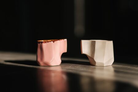 Ceramic cup for coffee on the table. Right is unfinished, left is readyの写真素材