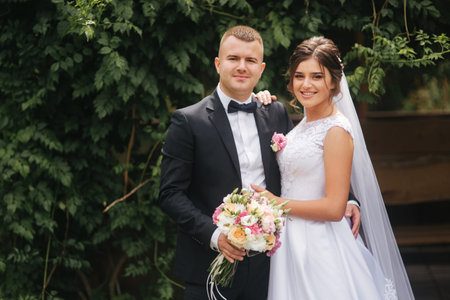 Portrait of handsome groom and charming bride. Romantic atmophere on the wedding